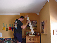 Dave installs the crown molding.