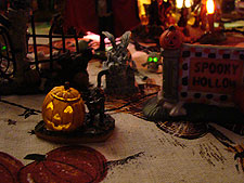 Tiny lighted Jack-O-Lanters & skulls with lighted eyes in back