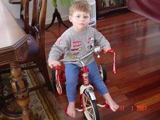 Hunter riding his trike.