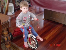 Hunter riding his trike.