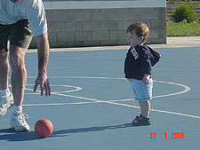 Hunter and daddy play with the basketball.