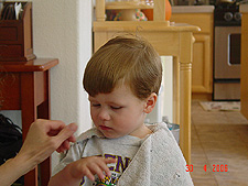 Mommy gives Hunter a haircut.