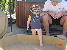 Hunter uses his sandbox to cool off....