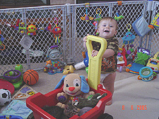 Hunter gives baby Allie and his toys a ride.