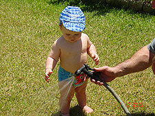 Hunter getting sprayed with the hose.