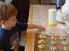 Hunter putting M&Ms on the cookies.