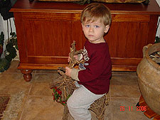 Hunter trying to ride the reindeer.