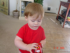 Hunter plays with his car.