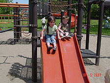 Olivia & Hunter go down the slide.