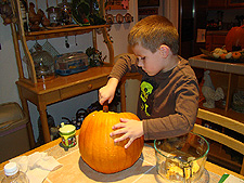 Hunter cleaning out a pumpkin