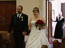 Alysia and her dad walk down the aisle. 