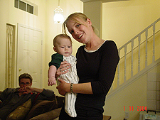 Karen holding hunter with Doug in the background..