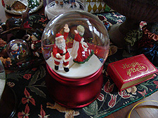 Snow globe & music box, they hold hands as they pass each other dancing.