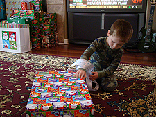 Hunter opening his gift.
