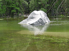 A rock jets out of Mirror Lake...