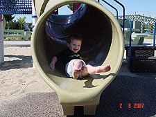 Hunter goes down the slide.