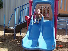 Hunter goes down the slide.